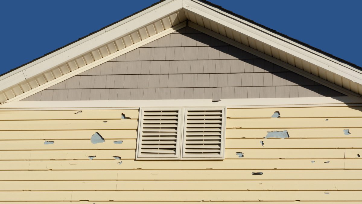 Holes in exterior siding in home from damage by hail storm