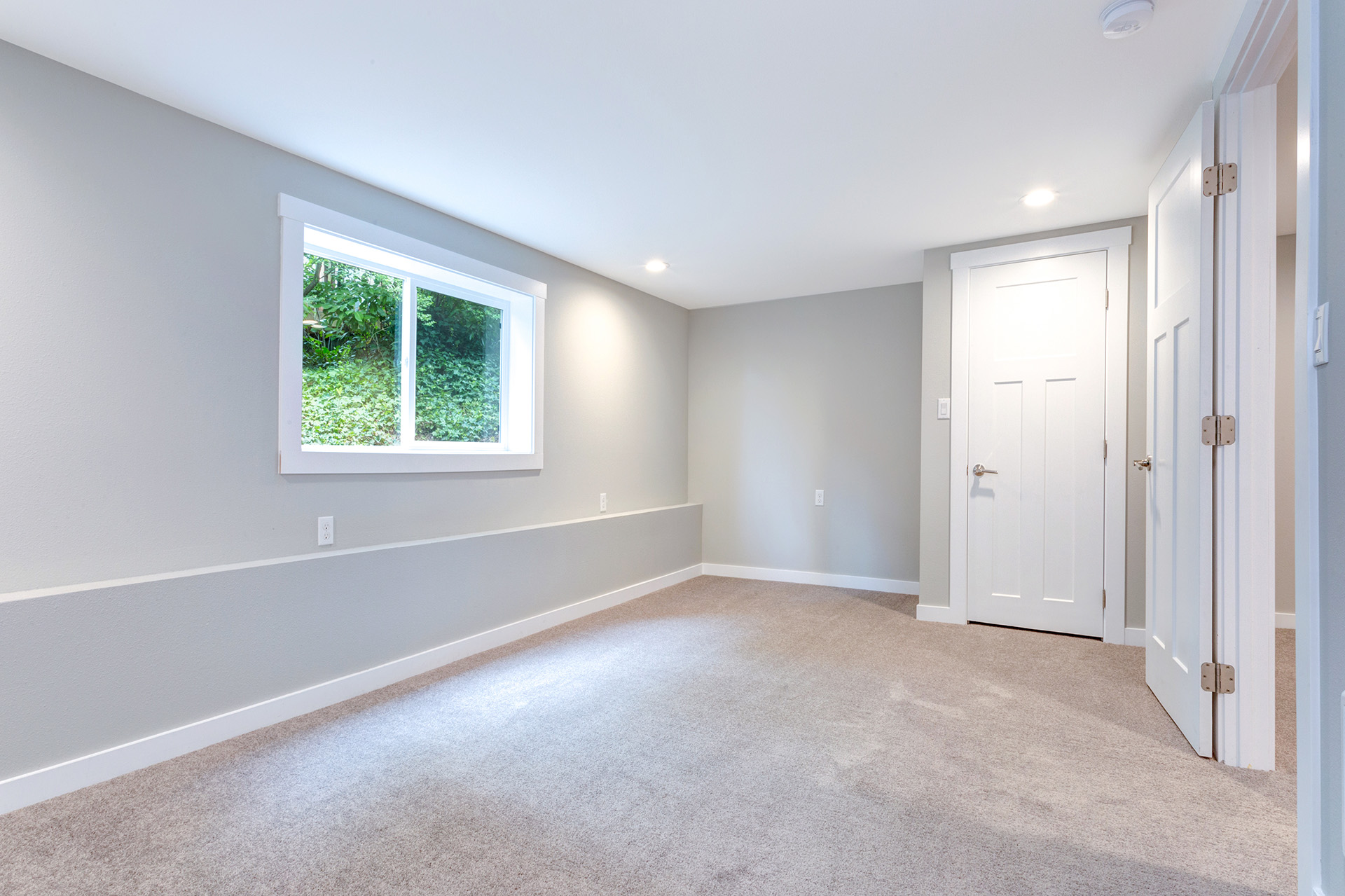 Grey bedroom interior with built in closet in a basement