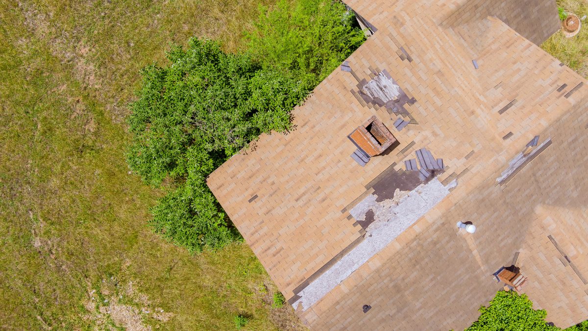 High winds and strong storms have damaged roof shingles from an aerial point of view