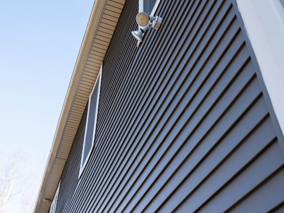 bluish gray siding on a two story house, side view from the bottom corner up